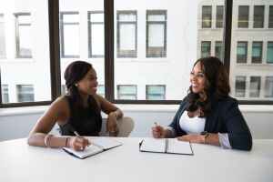 Two women sitting at desk