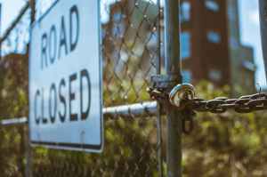 Road Closed Sign On Locked Gate