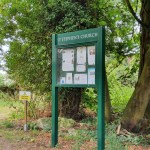 A Dark Green Church Noticeboard Outdoors