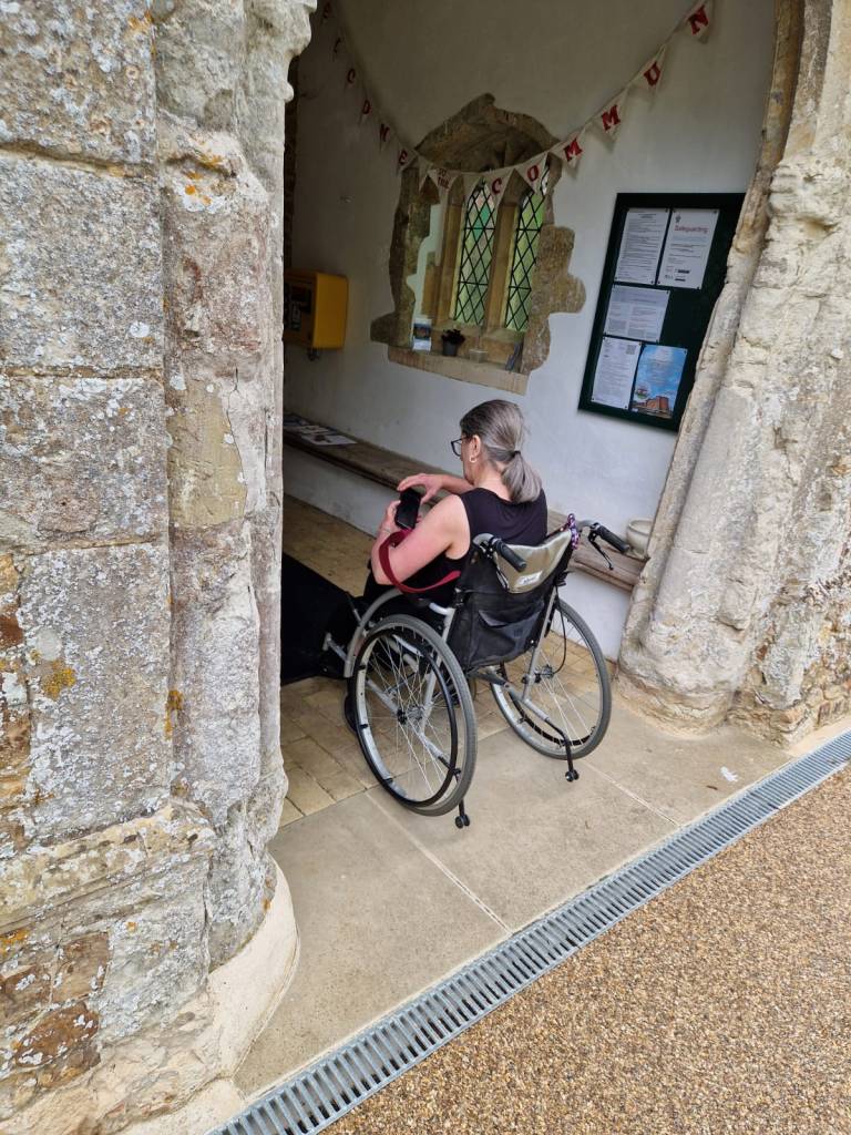 Wheelchair User In Church Porch