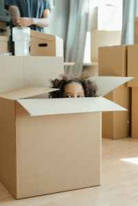 A Child Peeping Put Of A Packing Box