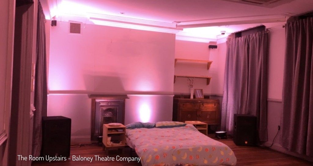 The Room Upstairs Room Stage Set With Muted Lighting In Purple Pink