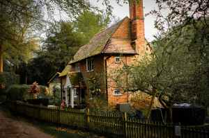 A Red Brick Cottage With Chimney